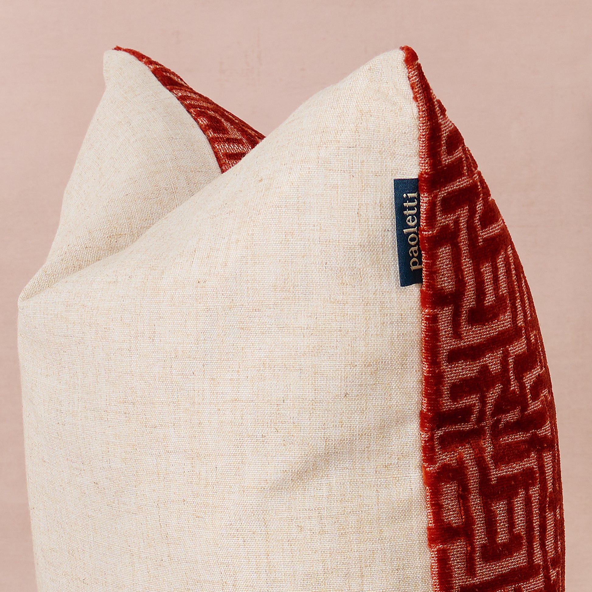 Textured Autumn cushion with red and beige pattern on a pink background