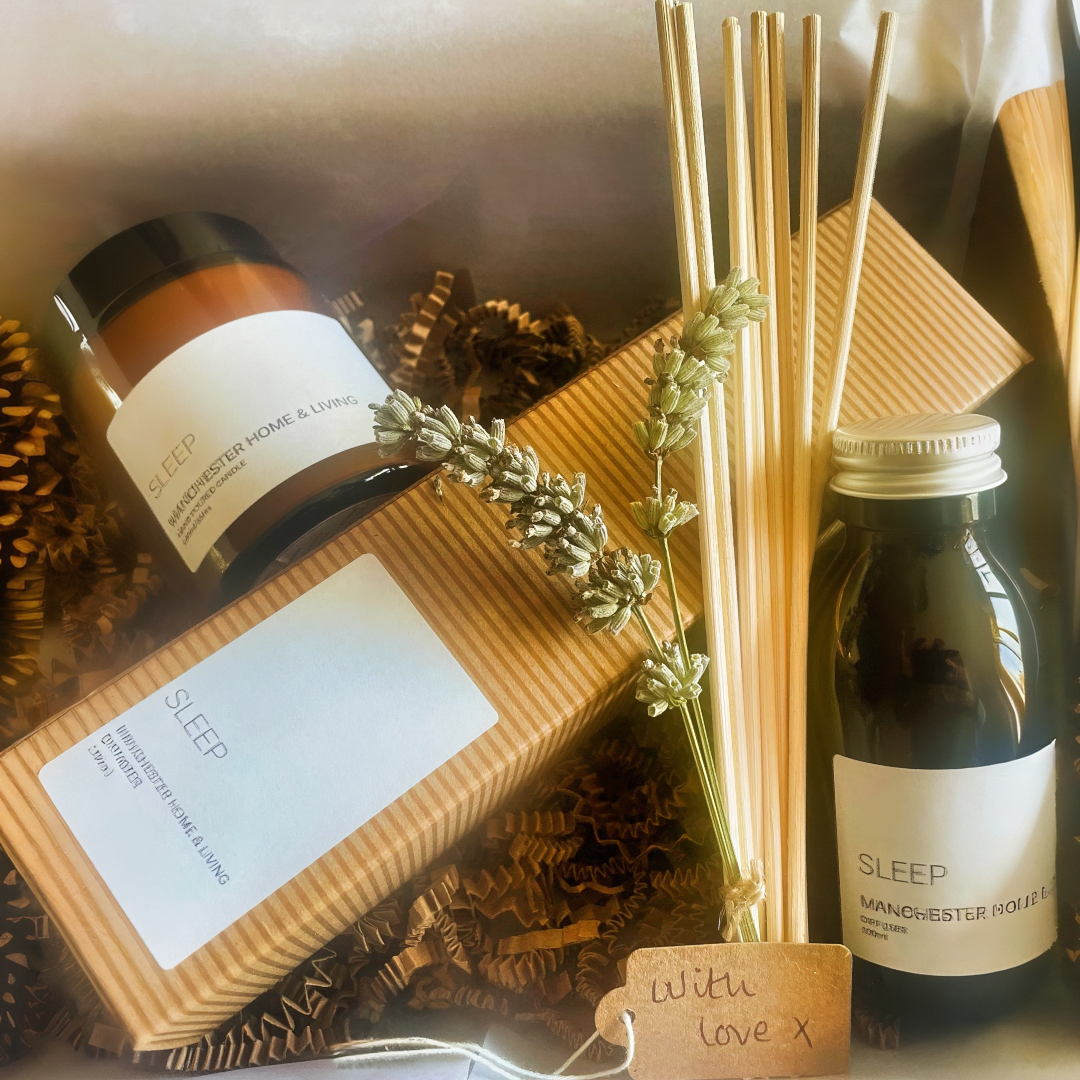 A gift set with a candle,and reed diffuser labelled 'Sleep' on a neutral background.