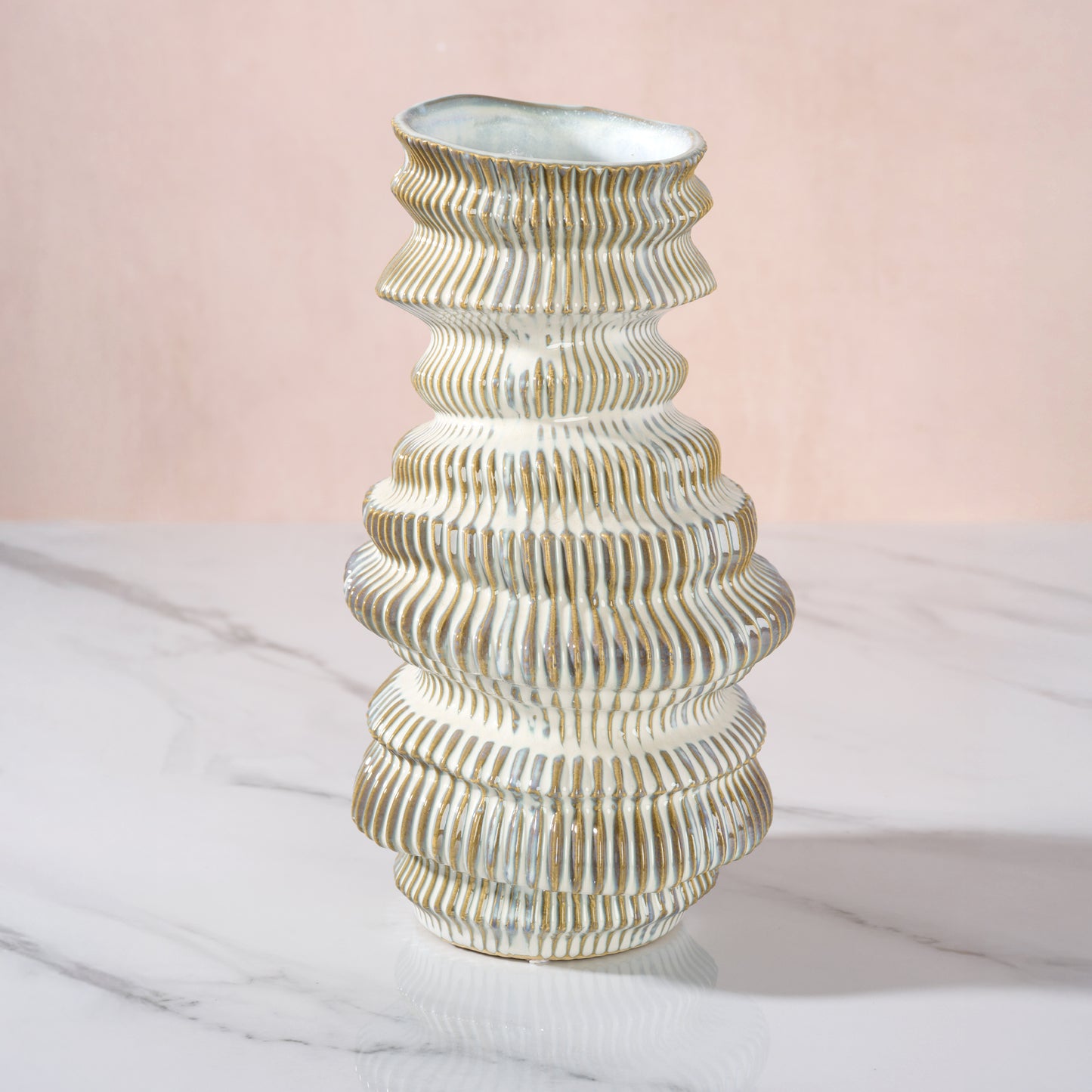 Decorative vase with ribbed design on a light pink background