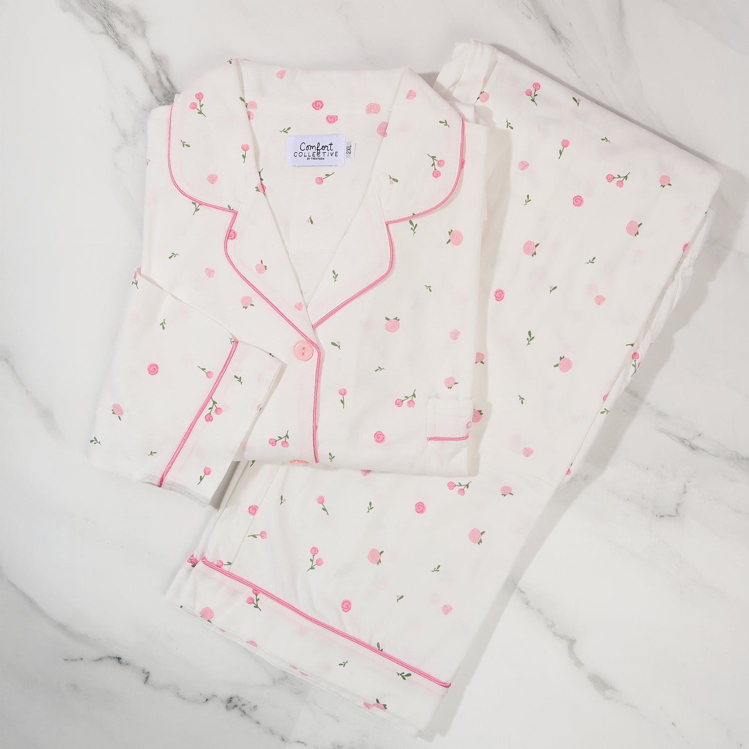 Women's cotton pyjamas on a marble background.